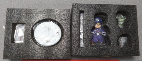 A figure held inside moulded packaging, photographed without being removed